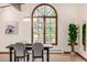 Bright dining room showcasing a large window, modern light fixture, and stylish decor at 6975 S Chase Ct, Littleton, CO 80128