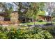 Charming brick home with landscaped yard, walkway, and mature trees at 6975 S Chase Ct, Littleton, CO 80128