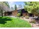 Stunning front exterior of the home featuring a brick facade, large windows, and a well-manicured lawn at 6975 S Chase Ct, Littleton, CO 80128