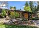 Charming exterior view of home, landscaped yard, featuring a patio with a table and chairs for outdoor enjoyment at 6975 S Chase Ct, Littleton, CO 80128