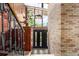 Grand foyer with wood paneling, a statement staircase, and natural light from large windows at 6975 S Chase Ct, Littleton, CO 80128
