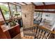 Open-concept view of the foyer, living room, and staircase, featuring wood accents and natural light at 6975 S Chase Ct, Littleton, CO 80128
