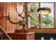Elegant foyer showcasing a decorative bonsai tree, wood accents, and a modern light fixture at 6975 S Chase Ct, Littleton, CO 80128