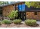 Up-close view of the front door and landscaping, featuring a brick exterior and stylish details at 6975 S Chase Ct, Littleton, CO 80128