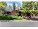 Beautifully landscaped front yard and exterior of a two-story brick home with modern architectural elements at 6975 S Chase Ct, Littleton, CO 80128