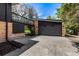 Spacious two-car garage with brick exterior and a second story landing with access to the backyard at 6975 S Chase Ct, Littleton, CO 80128