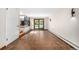 Hallway with tile flooring features natural light from glass patio doors and neutral paint at 6975 S Chase Ct, Littleton, CO 80128