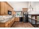 Kitchen with granite countertops, stainless steel appliances, and wooden cabinetry at 6975 S Chase Ct, Littleton, CO 80128