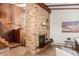 Living room featuring a striking brick fireplace, hardwood floors, and elegant decor at 6975 S Chase Ct, Littleton, CO 80128