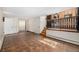 Open-concept living room features tile floors, stairwell, and an adjacent kitchen area at 6975 S Chase Ct, Littleton, CO 80128