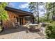 A patio with a dining table, chairs, landscaped yard, complemented by natural lighting and outdoor space for relaxation at 6975 S Chase Ct, Littleton, CO 80128