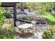 Outdoor patio with a table and chairs, featuring landscaping, flowers, and a built-in bench for relaxed outdoor gatherings at 6975 S Chase Ct, Littleton, CO 80128