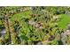 Aerial view of large property with tennis court surrounded by mature trees and landscaping at 1700 E Tufts Ave, Cherry Hills Village, CO 80113