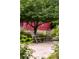 Serene backyard featuring a seating area under a tree with a glimpse of a charming red shed at 1700 E Tufts Ave, Cherry Hills Village, CO 80113