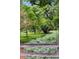 Lush backyard featuring mature trees, manicured lawns, and beautiful landscaping at 1700 E Tufts Ave, Cherry Hills Village, CO 80113