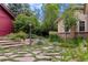 Beautiful backyard featuring stone walkways, lush landscaping, and a well-maintained lawn at 1700 E Tufts Ave, Cherry Hills Village, CO 80113