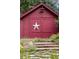 Charming red barn featuring a large star and stone steps at 1700 E Tufts Ave, Cherry Hills Village, CO 80113