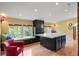 Bright bonus room with a bay window, an island table, recessed lighting, and a comfortable armchair at 1700 E Tufts Ave, Cherry Hills Village, CO 80113