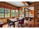 Traditional dining room with wood trim, hardwood floors, and lots of natural light from large windows at 1700 E Tufts Ave, Cherry Hills Village, CO 80113