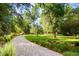 Long, winding driveway through a lush, green lawn at 1700 E Tufts Ave, Cherry Hills Village, CO 80113