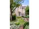 Charming home featuring a well-manicured lawn, stone accents, and lush landscaping at 1700 E Tufts Ave, Cherry Hills Village, CO 80113