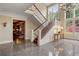 Grand two-story foyer with marble floors, staircase, and views to the living room at 1700 E Tufts Ave, Cherry Hills Village, CO 80113
