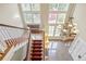 Bright foyer with a view of the staircase, a chandelier, and large windows at 1700 E Tufts Ave, Cherry Hills Village, CO 80113