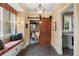 Charming hallway with a barn door, window seat, and access to the laundry room at 1700 E Tufts Ave, Cherry Hills Village, CO 80113