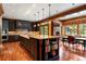 Open kitchen layout with center island, dark cabinets, and adjacent breakfast nook at 1700 E Tufts Ave, Cherry Hills Village, CO 80113