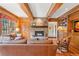 Open living room showcasing a stone fireplace, built-in bookshelves, and comfortable seating at 1700 E Tufts Ave, Cherry Hills Village, CO 80113