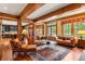 Spacious living room with hardwood floors, wood beam accents and large windows at 1700 E Tufts Ave, Cherry Hills Village, CO 80113