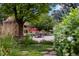 Charming outdoor patio with stone seating area, stone walls, and lush garden at 1700 E Tufts Ave, Cherry Hills Village, CO 80113