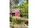 Backyard shed features a large star, surrounded by lush greenery at 1700 E Tufts Ave, Cherry Hills Village, CO 80113