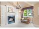 Sitting area with a fireplace, comfortable seating, and a large window overlooking the backyard at 1700 E Tufts Ave, Cherry Hills Village, CO 80113