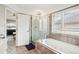 Bright primary bathroom with a glass-enclosed shower, large tub and a sink at 5058 E Cherry Creek South Dr, Denver, CO 80246