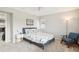 Cozy bedroom features a queen-size bed, nightstands, and a sitting chair at 5058 E Cherry Creek South Dr, Denver, CO 80246