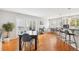 Dining room with wood floors, a large table, and easy access to the outdoor balcony at 5058 E Cherry Creek South Dr, Denver, CO 80246