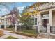 Charming home with well-maintained landscaping, a black iron fence, and an inviting front entrance at 5058 E Cherry Creek South Dr, Denver, CO 80246