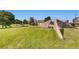 Expansive green space showcases public art, mature trees, and a serene park setting at 5058 E Cherry Creek South Dr, Denver, CO 80246