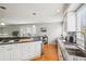 Spacious kitchen with stainless appliances, granite counters, and seamless flow to dining area at 5058 E Cherry Creek South Dr, Denver, CO 80246