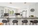 Well-lit kitchen with breakfast bar, stainless steel appliances, and white cabinetry at 5058 E Cherry Creek South Dr, Denver, CO 80246