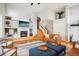 Open-concept living room with high ceilings, fireplace, and comfortable seating arrangement at 5058 E Cherry Creek South Dr, Denver, CO 80246