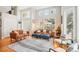Bright living room featuring large windows, hardwood floors, and stylish furnishings at 5058 E Cherry Creek South Dr, Denver, CO 80246