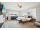 Bright main bedroom with a ceiling fan, and a bench at the end of the bed at 5058 E Cherry Creek South Dr, Denver, CO 80246