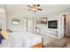 Spacious main bedroom with a fireplace, tv, closet and ensuite bath at 5058 E Cherry Creek South Dr, Denver, CO 80246