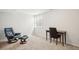 Bright room featuring comfortable black armchair, ottoman, and a sleek desk by the window at 5058 E Cherry Creek South Dr, Denver, CO 80246