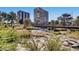Scenic river view with modern glass buildings in background, surrounded by lush greenery and rocks at 5058 E Cherry Creek South Dr, Denver, CO 80246