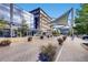 Street view in Cherry Creek North shows modern buildings, shops, and landscaped sidewalks at 5058 E Cherry Creek South Dr, Denver, CO 80246