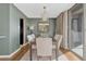 Dining room featuring a modern table and chairs set, contemporary lighting, and a glass sliding door at 955 Eudora St # 1502, Denver, CO 80220