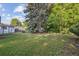 Spacious backyard with lush lawn and mature trees at 2105 S Irving St, Denver, CO 80219